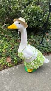 A summer-ready porch goose wearing a colorful floral bikini