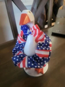 A tabletop goose wearing an America 250th anniversary commemorative outfit