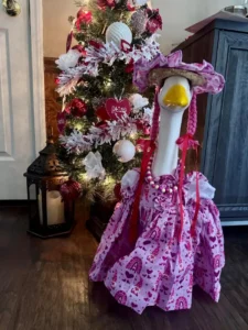 An elegant porch goose wearing a fancy purple noble lady outfit with a hat